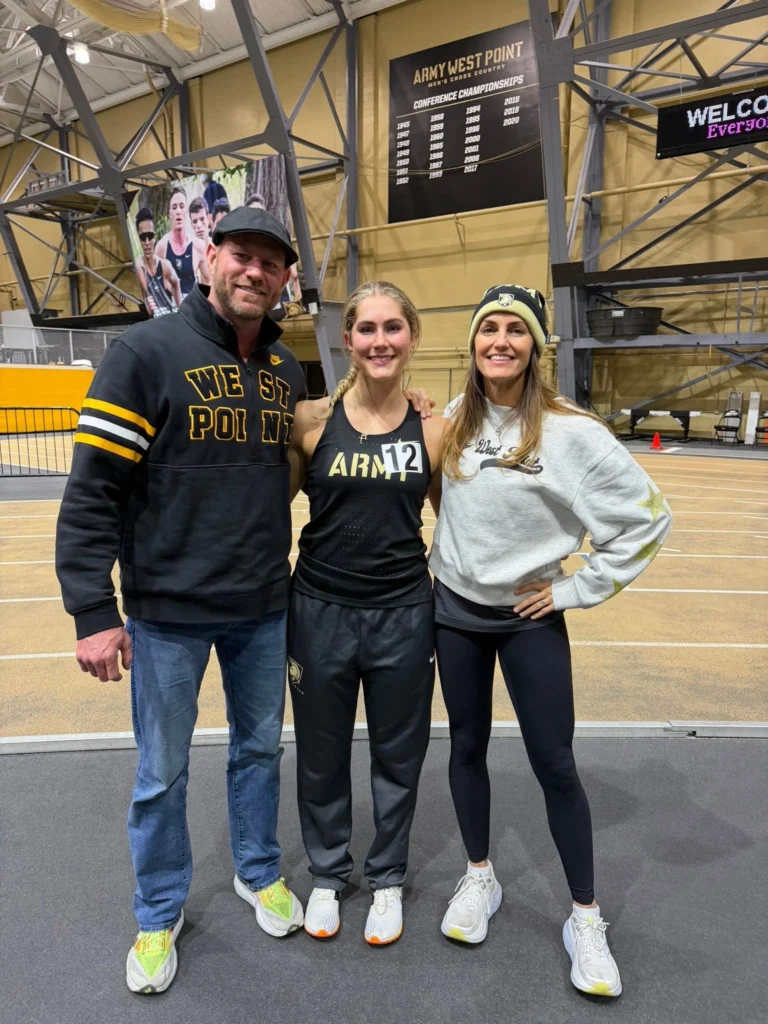 April Liles at the West Point indoor track facility with an athlete and coach