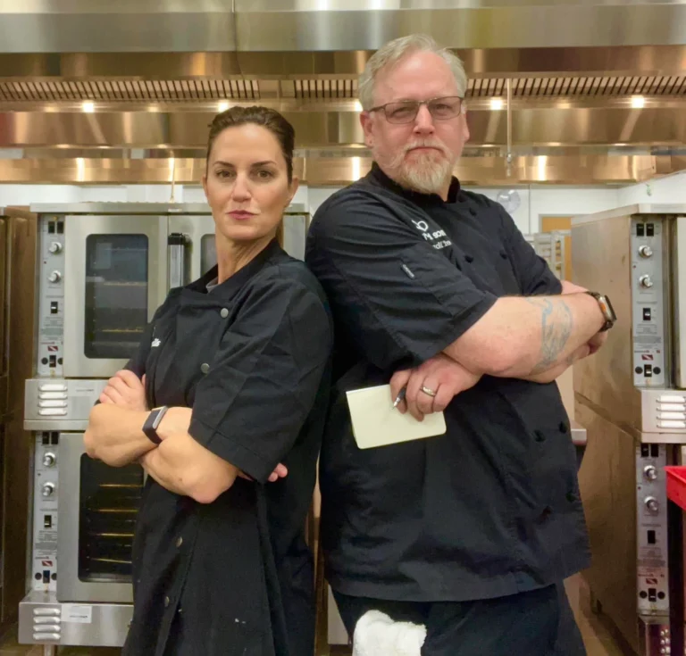 April Liles in a professional foodservice kitchen with a fellow culinary professional