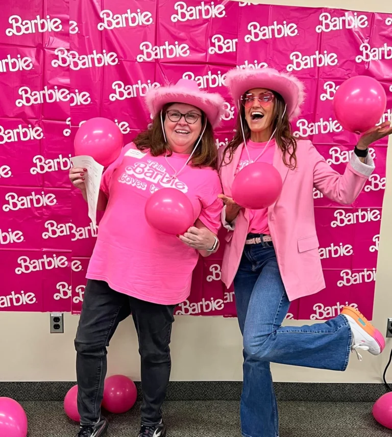 April Liles and colleague dressed in pink at a Barbie-themed Waltham school nutrition team event