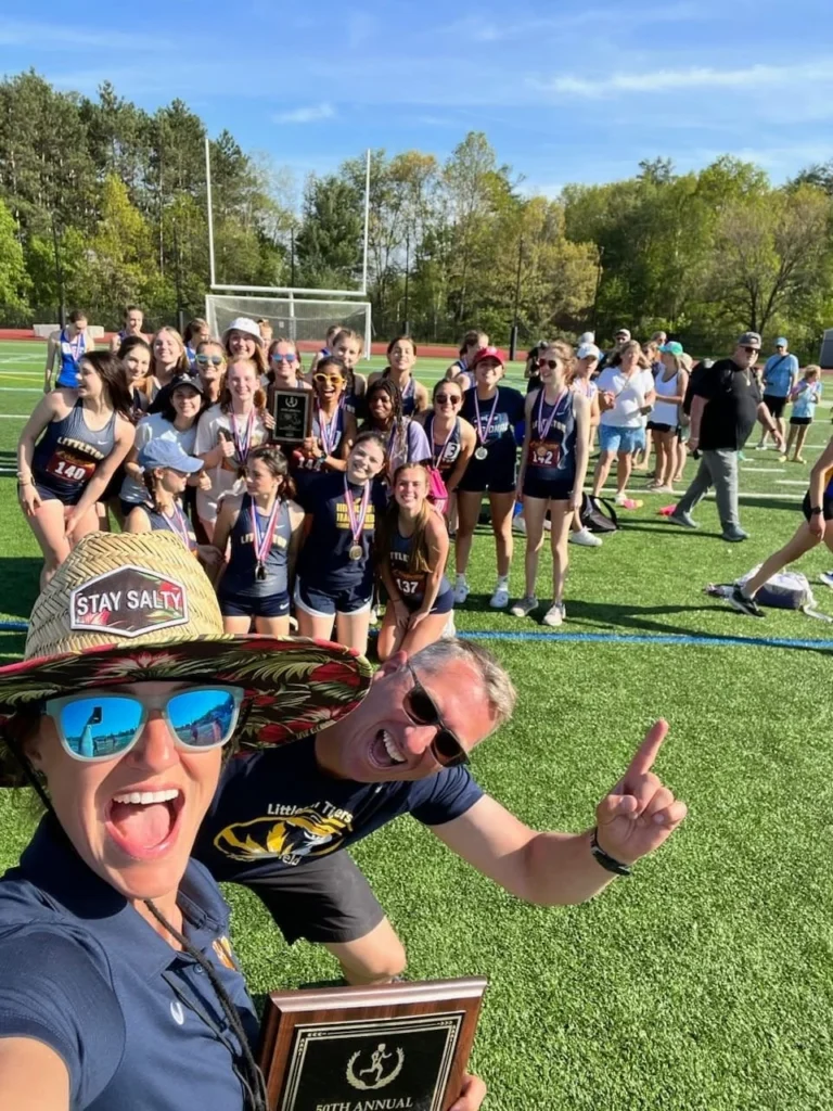 April Liles celebrating with the Littleton track and field team after a competition